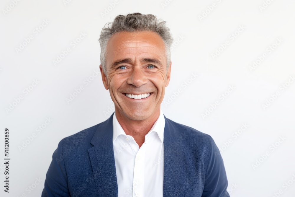 Portrait of a handsome mature man smiling while standing against white background Portrait of a handsome mature man smiling while standing against white background