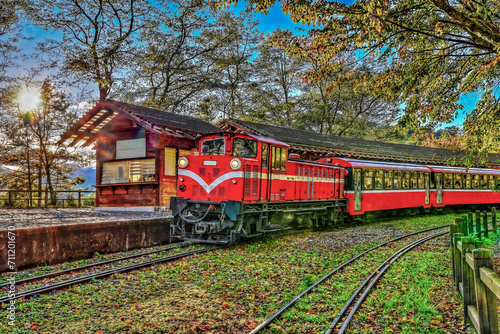 Fascinating forest train passing by station at the Alishan National Forest Recreation Area on Dueigaoyue Station.Scenic tree view , Attractive arc track in Alishan,Taiwan.For branding, screensavers.