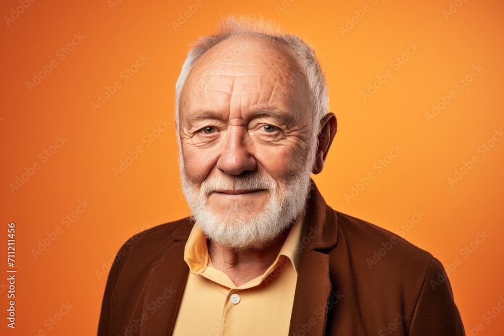 Portrait of an old man with a beard on an orange background Portrait of an old man with a beard on an orange background