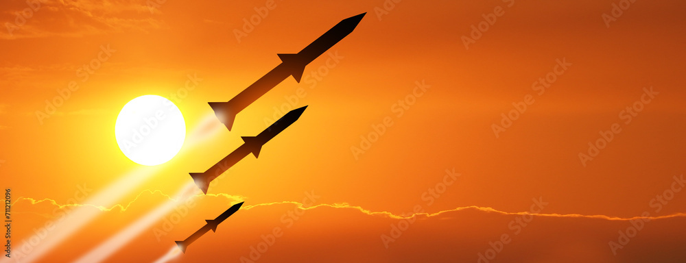 Fired missiles fly to the target. Missiles at the sky at sunset. Missile defense. Rockets attack concept. - obrazy, fototapety, plakaty 