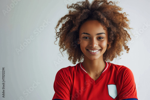 Afro woman wearing soccer player or supporter attribute uniform © Aris