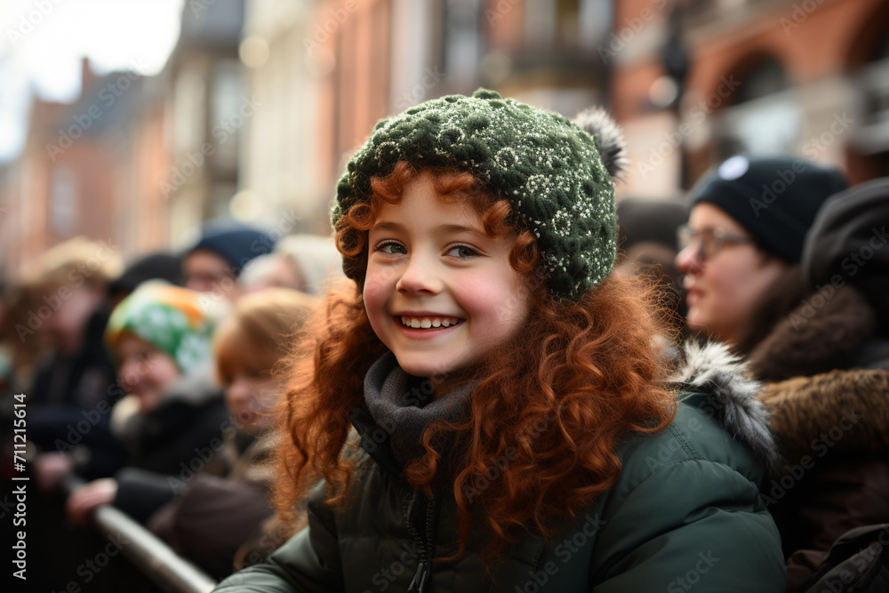 A smiling red haired girl with green clothes at the St. Patrick's Day parade in an Irish town