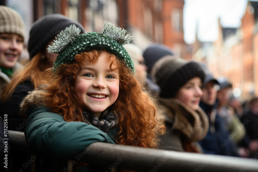 A smiling red haired girl with green clothes at the St. Patrick's Day parade in an Irish town