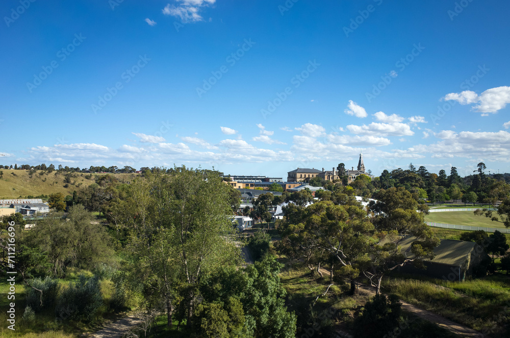 Elevated view of the suburb of Sunbury with trees and heritage buildings in the distance. Melbourne VIC Australia. It is on the outskirts of Melbourne's urban fringe, considered a satellite township.