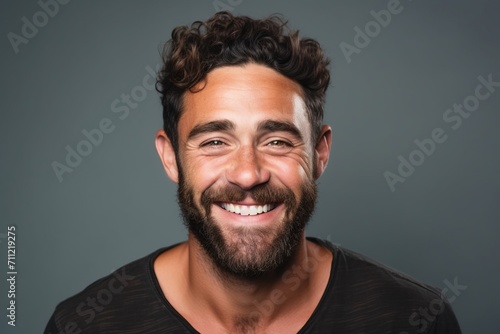 Portrait of a handsome man with a beard on a gray background © Inigo