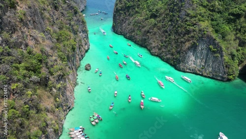 Boats in vibrant Pileh Lagoon of Phi phi island on sunny day, Aerial photo