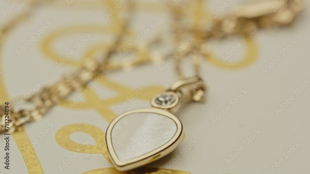 Macro of beautiful diamond decorated located on a golden necklace Macro of beautiful diamond decorated located on a golden necklace