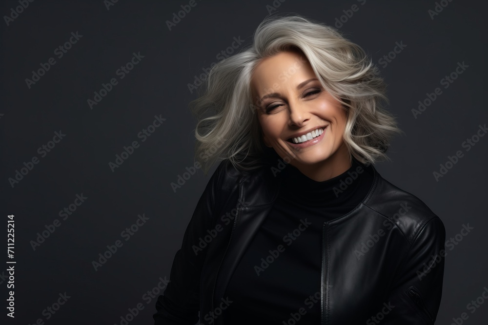 Portrait of a beautiful middle-aged woman in black leather jacket.