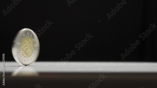 Canadian 2 Dollar Coin Spinning on Table photo