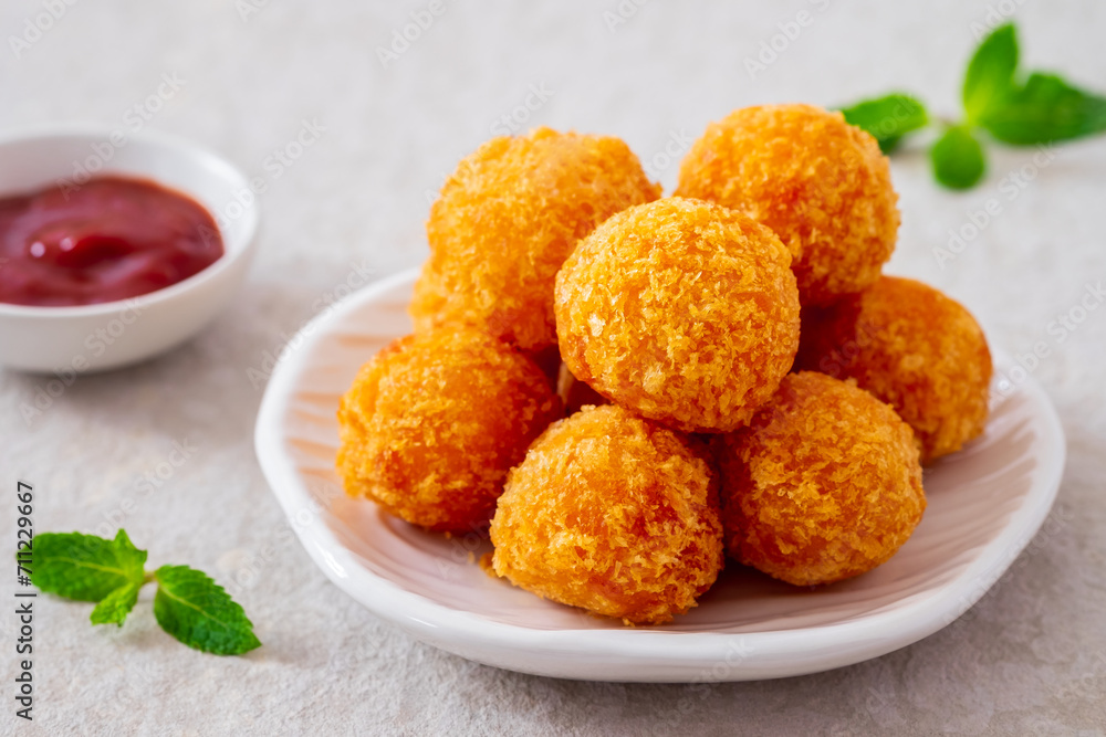Deep fried cheese balls on plate and ketchup Deep fried cheese balls on plate and ketchup