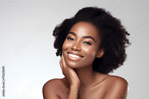 Young and beautiful African American woman hand on her face with flawless healthy skin for female skin care promotion and ads. Hydration beauty flawless skin. Closeup face beauty portrait. 