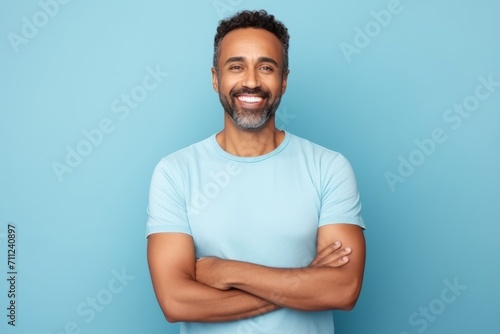 happy african american man in blue t-shirt on blue background