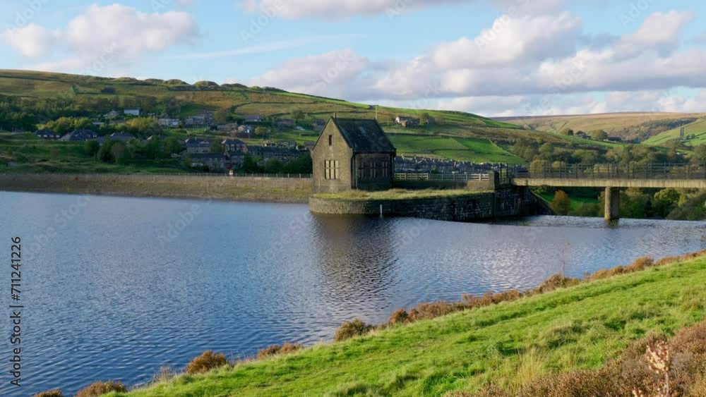 Overflow structures on a man-made dam in Yorkshire, UK. Scenery of a landscape near Marsden, Huddersfield. Reservoir and waterworks with fresh water running down the spillway Overflow structures on a man-made dam in Yorkshire, UK. Scenery of a landscape near Marsden, Huddersfield. Reservoir and waterworks with fresh water running down the spillway