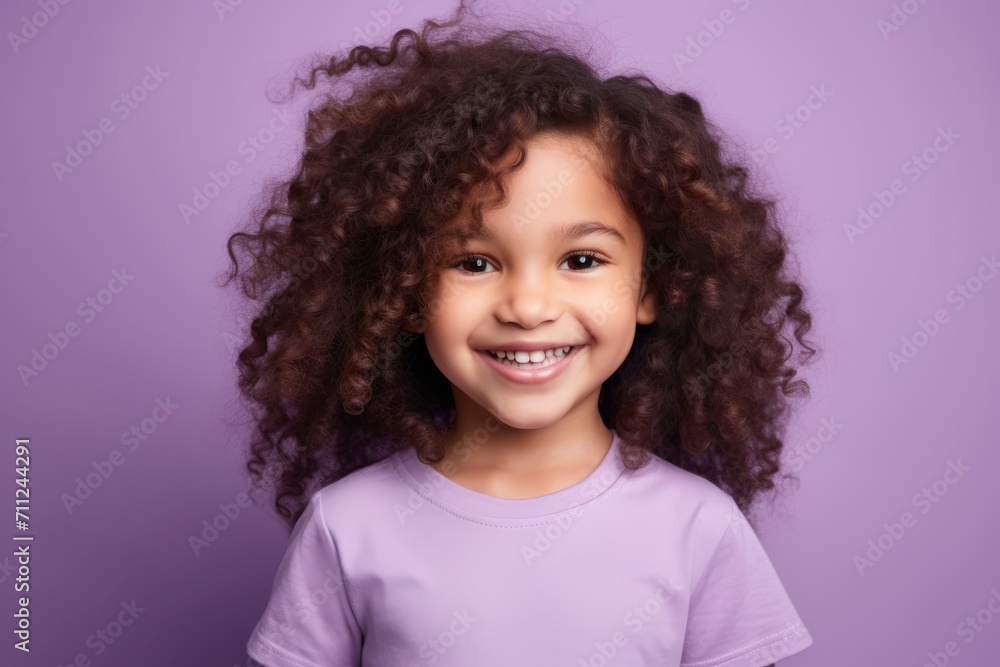 Portrait of a smiling little girl with curly hair against purple background Portrait of a smiling little girl with curly hair against purple background