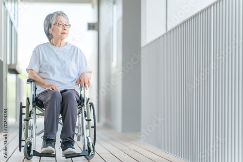 病院・老人ホームで車椅子に乗る高齢者女性（介護・リハビリ） 
