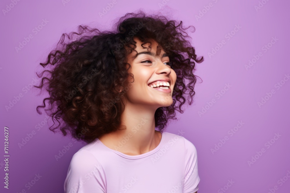 Portrait of beautiful african american woman with curly hair on violet background