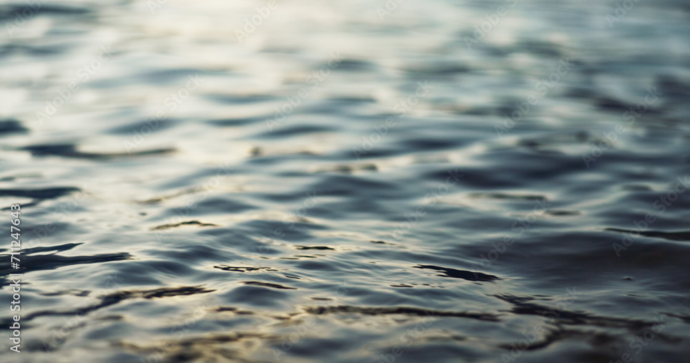 Naklejka premium Water, ripple and nature with environment and lake, river or ocean with waves, calm and closeup. Earth, sea and natural background, moving liquid is tranquil and abstract with texture and light