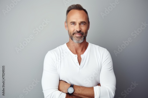 Portrait of a handsome mature man in a white t-shirt.