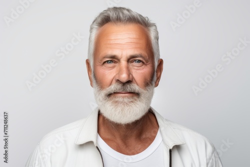 Portrait of handsome senior man with white beard. Isolated on grey background.