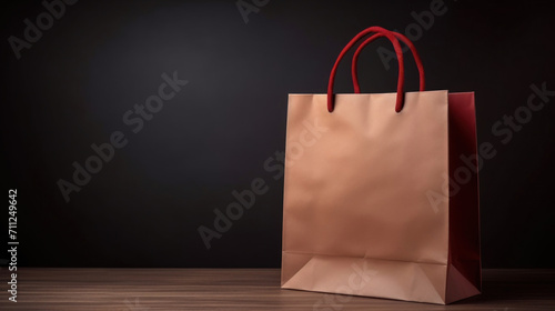 An elegant brown paper shopping bag with red handles stands on a wooden table against a dark background, symbolizing eco-friendly packaging.
