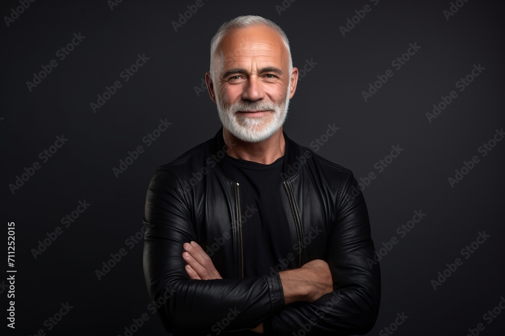 Portrait of a handsome senior man in leather jacket on dark background Portrait of a handsome senior man in leather jacket on dark background