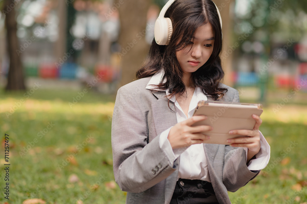 Female Asian Girl playing game on digital tablet
Female Asian Girl playing game on digital tablet