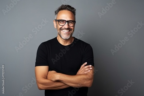 Portrait of a smiling middle-aged man with glasses and a black T-shirt.