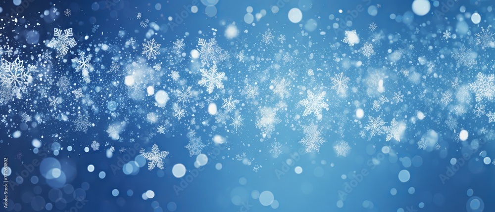 Obraz premium Winter wonderland: snowflakes and bokeh effect on a blue background