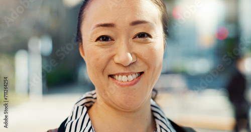 Mature, Asian woman in city and face with travel or commute to work and professional in Tokyo. Corporate lawyer in urban street, journey to office and happiness in portrait with business mindset
