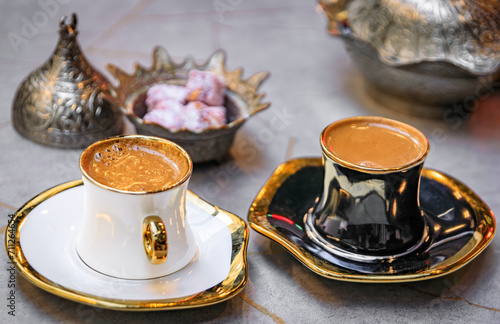 Cups of traditional Turkish coffee or turk kahvesi served with loukum or Turkish delight candy at a restaurant in Sultanahmet, Istanbul, Turkey photo