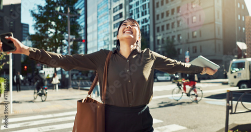 Dancing, happy and business woman in the city for job promotion, celebration or achievement. Smile, good news and professional young Asian female person moving and commuting in urban town road.