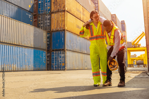 black african worker accident leg injury medic medical team staff help support in port cargo container yard photo