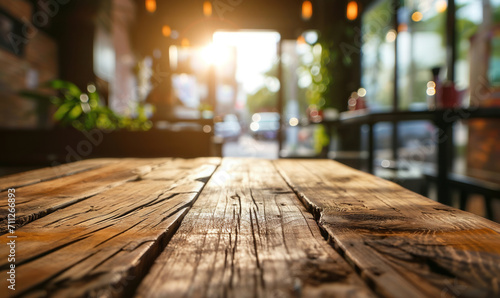 Empty wooden table with sunny cozy cafe interior on background
