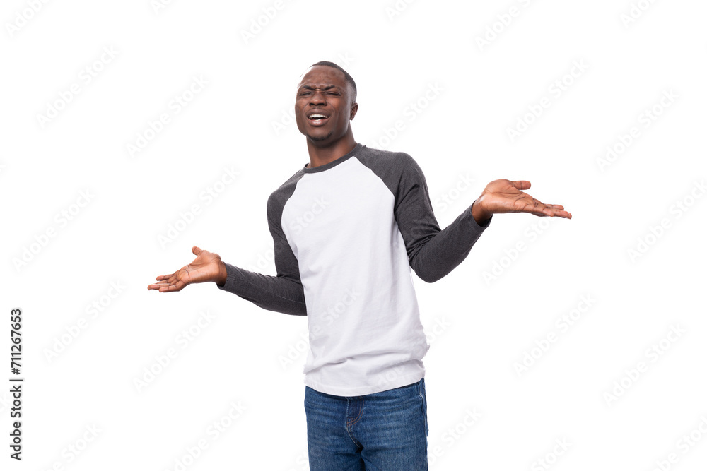 young slender African guy dressed in a black and white sweatshirt posing for the camera young slender African guy dressed in a black and white sweatshirt posing for the camera