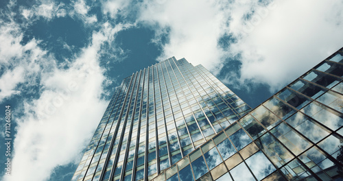 Schilderij op canvas Low angle, skyscraper building and clouds with reflection, nature or urban infrastructure in city