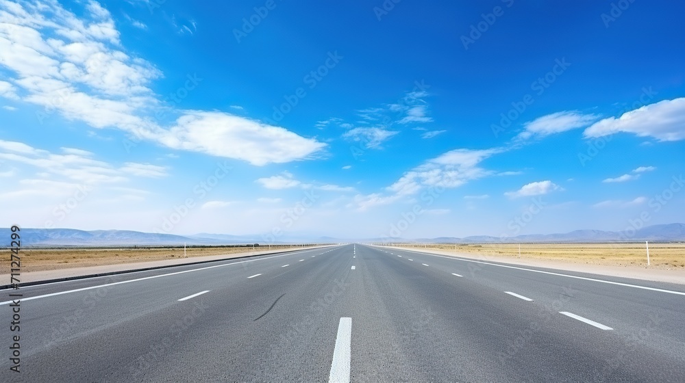 highway in the grassland background of blue sky and bright clouds, long road stretches into the distance. empty street on a beautiful sunny day highway in the grassland background of blue sky and bright clouds, long road stretches into the distance. empty street on a beautiful sunny day