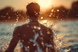 Man Standing Against a Sunset with Water Splashing