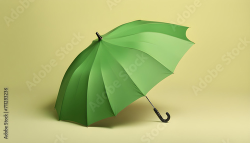 Stylish open green umbrella on yellow background