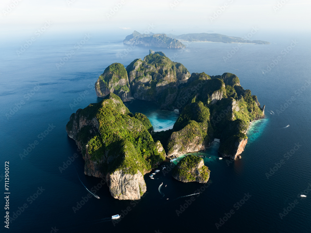 Stunning aerial view of Ko Phi Phi Lee, a ring of steep limestone hills surrounding Maya Bay with Phi Phi Don in the distance. Phi Phi Islands, Andaman Sea, Krabi, Thailand.