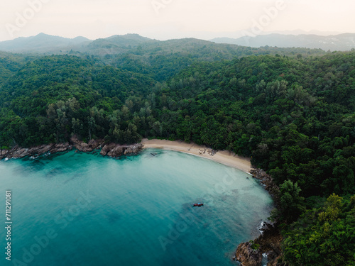 Fototapeta Naklejka Na Ścianę i Meble -  View from above, stunning aerial view of Banana beach, a beautiful white sand beach surrounded by palm trees and bathed by a turquoise water. Phuket, Thailand.