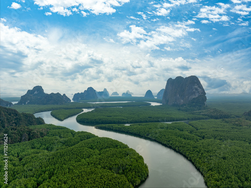 View from above, stunning aerial view of Ao Phang Nga (Phang Nga Bay) National Park featuring a multitude of limestone formations rising majestically from the sea near the coast. Thailand.