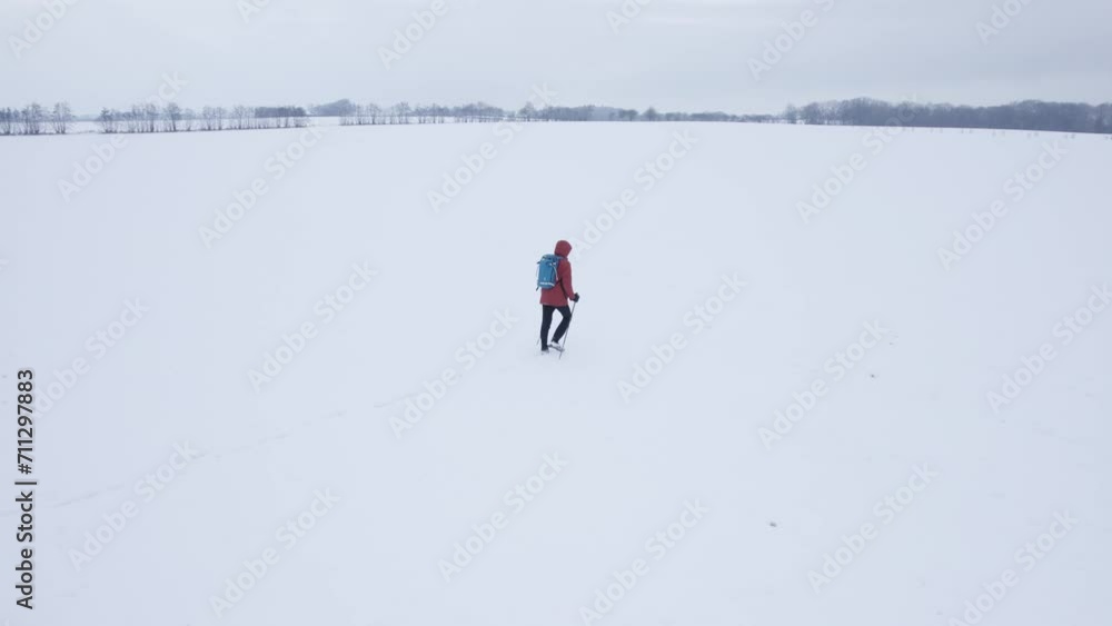 Man With Trekking Pole Is Walking In Snow During Winter Hike. Aerial Shot Man With Trekking Pole Is Walking In Snow During Winter Hike. Aerial Shot