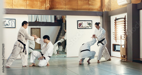 Students, karate or people learning in dojo for fitness, martial arts discipline or self defense combat. Demonstration, workout or kung fu master training athletes for fighting, education or class