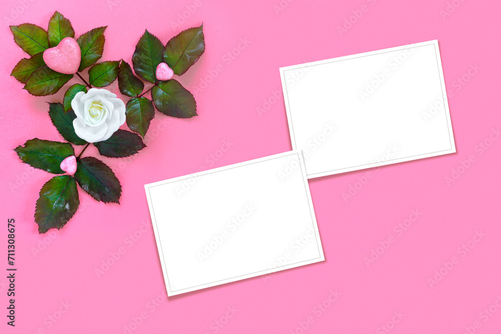 Beautiful white roses with green foliage and heart for Valentine's Day on pink paper background. Creative greeting card. Beautiful white roses with green foliage and heart for Valentine's Day on pink paper background. Creative greeting card.