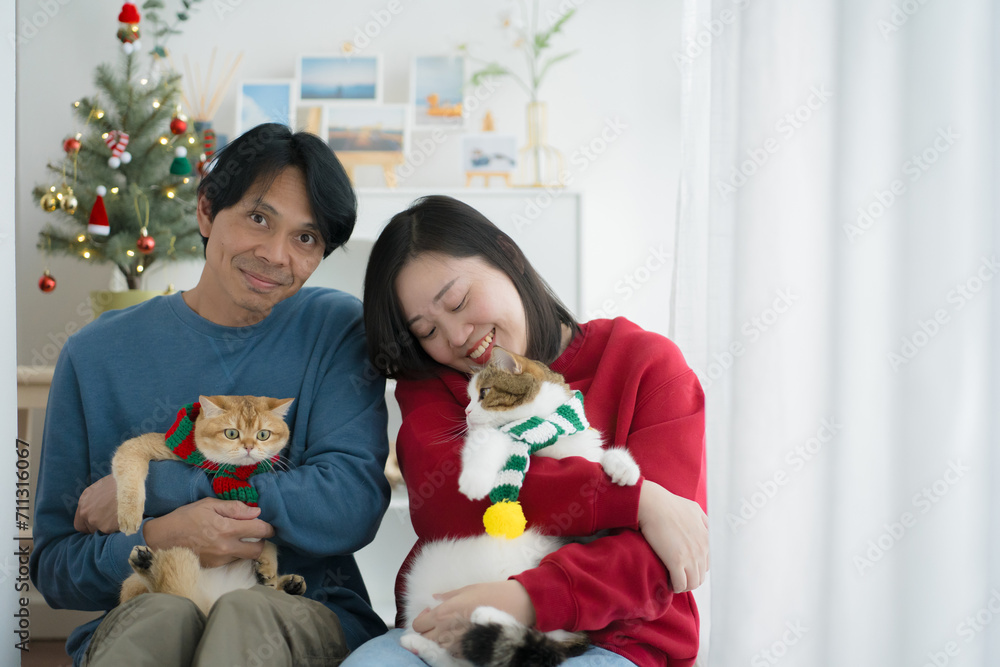 wellness at home concept with asian couple happy decorate house and play with cat at livingroom wellness at home concept with asian couple happy decorate house and play with cat at livingroom