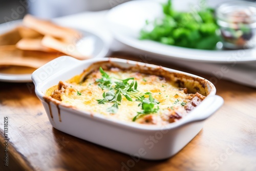 baked lasagna in a dish with bubbling cheese