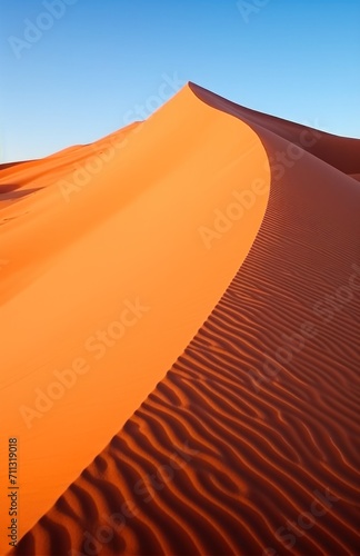 sand wave is blown from one spot in the dunes of namibia sand