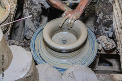 Potter's hands mold clay on a potter's wheel for planting plants. Environmentally friendly products made by human hands,Stay home and work from home.