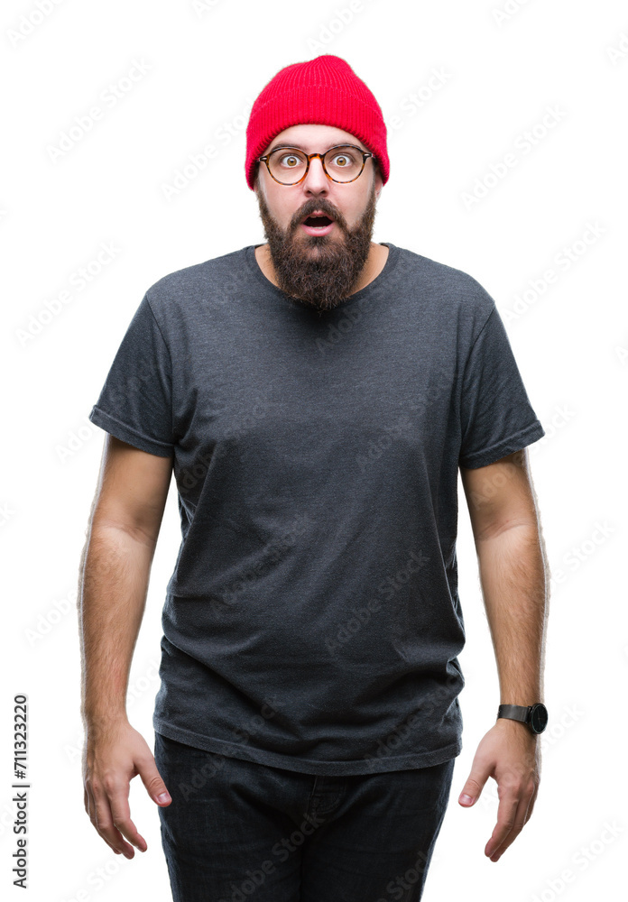 Young caucasian hipster man wearing glasses over isolated background afraid and shocked with surprise expression, fear and excited face.