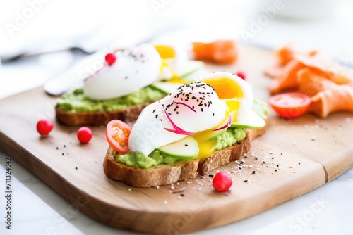 avocado and poached egg open sandwich with radish slices